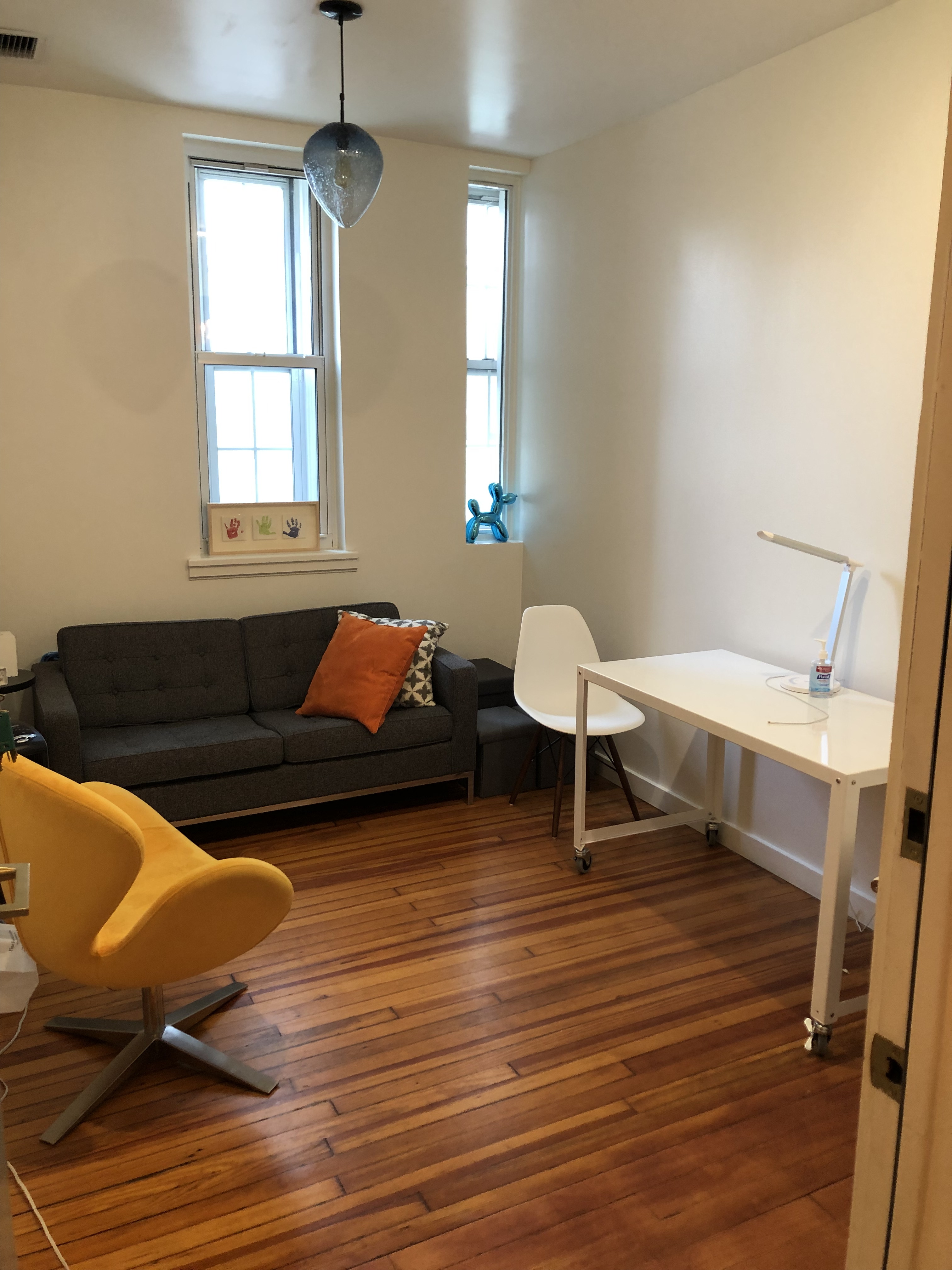 Clean and organized therapy office with light decor